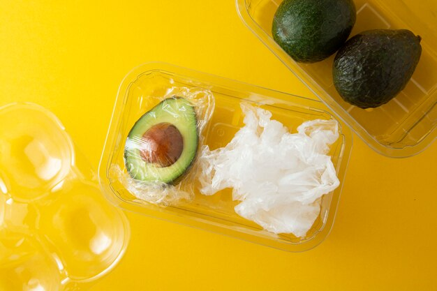 Avocado half with pit left in and wrapped tightly in plastic wrap to prevent browning